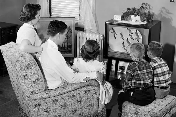 Family sitting around the TV