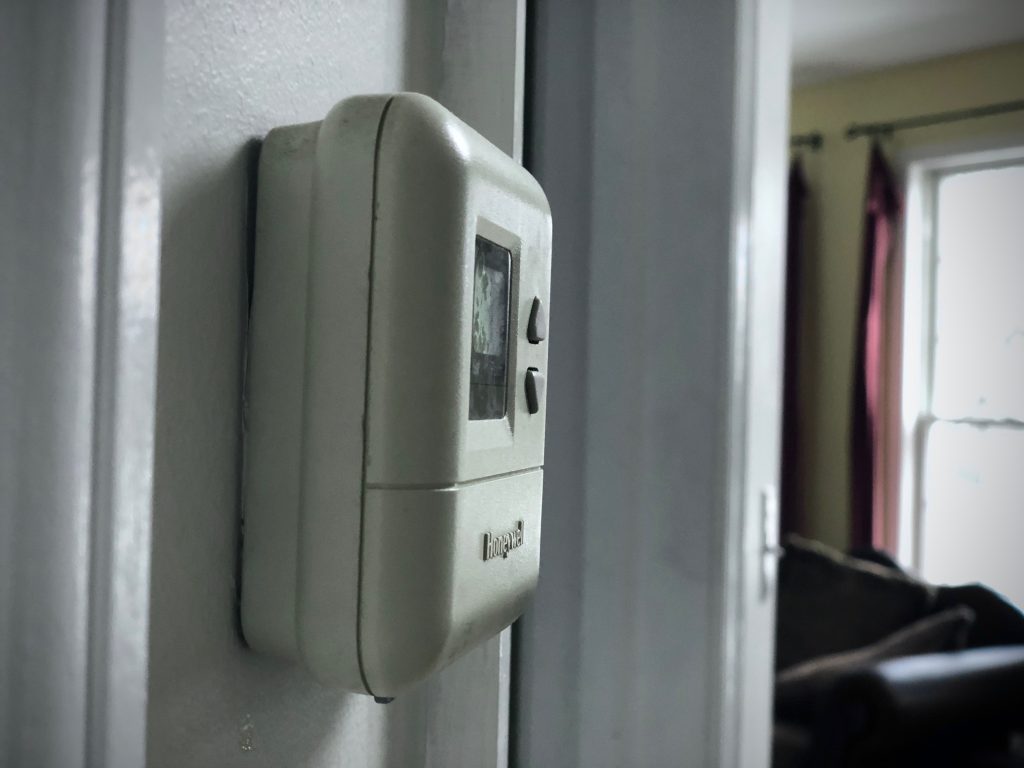 Thermostat mounted to wall