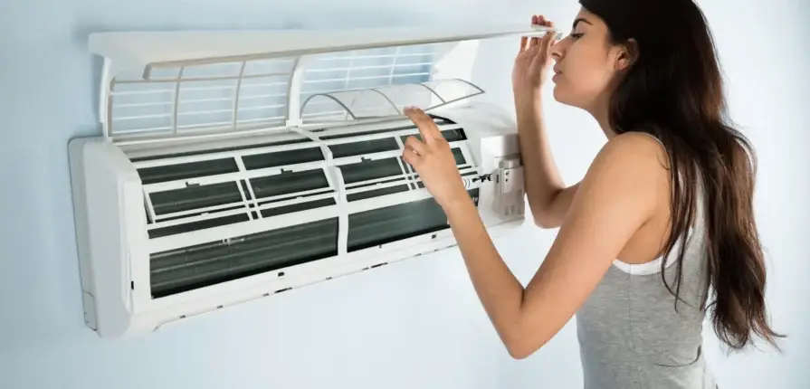 Woman checking her HVAC filter